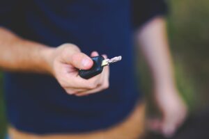 New car key and fob shown in the hands of a person.
