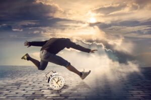 Pictured "Springing forward" a man leaps over a clock.