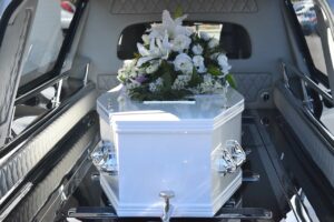 When Social Media Becomes Fatal blog post by Ken Walker Writer. Pictured: A coffiin, topped with flowers in the back of a hearse.