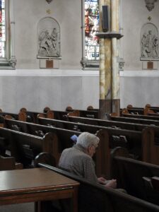 Pictured: A lone man sitting in a church pew.