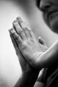 New Year Brings Same Flawed Leaders blog post by Ken Walker Writer. Pictured: A black and white photo of a person with hands folded in prayer.