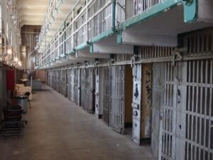 Pictured: A row of cells in aa run down prison.