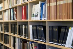 Pictured: A shelf of research books in a library.