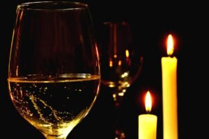 Pictured: Wine glasses lit by candlelight.