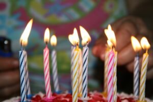 Stay Active to Stay Alive blog post by Ken Walker Writer. Pictured: A birthday cake with lit candles.