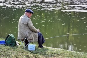Pictured: A retired man sitting by a pond fishing.