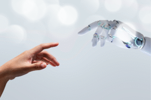 Pictured: A human hand and a robot hand reaching toward each other.