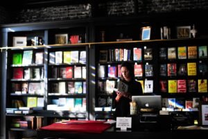 Buying Bestsellers: A New Old Practice blog post by Ken Walker Writer. Pictured: A patron browses in a book shop.