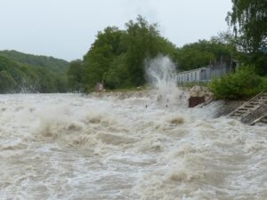 A Pair of Miraculous Storm Stories blog post by Ken Walker Writer. Pictured: Surging flood waters.