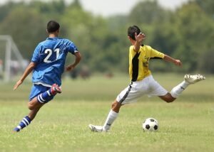 Pictured: Two men playing soccer.