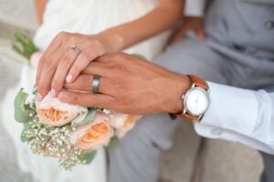 Dolly Parton Was an Example blog post by Ken Walker Writer. Pictured: A wedding picture of the couple holding hands over a bouquet of flowers.